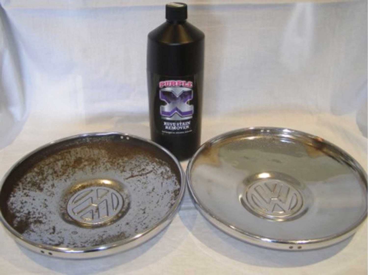 Rusty chrome VW hubcap next to one cleaned with Rustbuster Purple-X rust stain remover