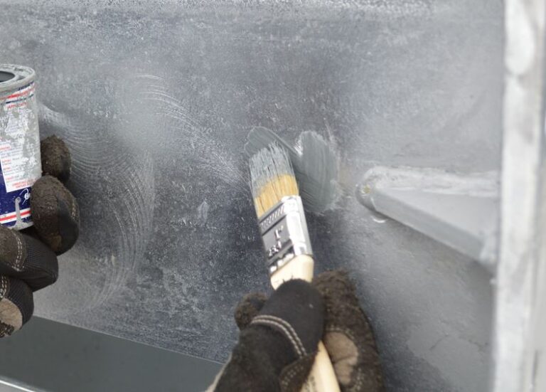 Brushing Rustbuster zinc rich epoxy primer onto bare steel