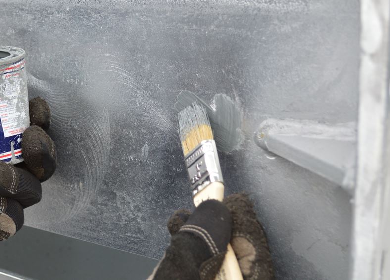 Brushing Rustbuster zinc rich epoxy primer onto bare steel